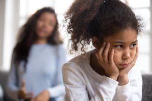 Upset African American preschooler girl looking in distance