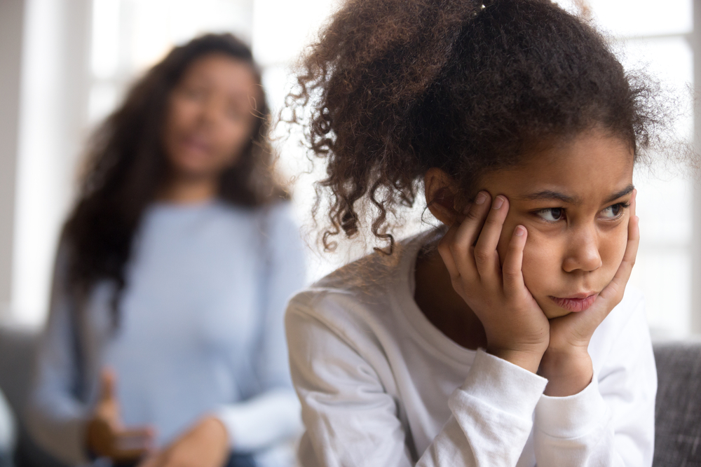 Upset African American preschooler girl looking in distance